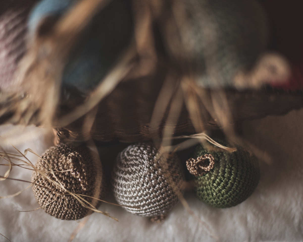 a group of knitted balls sitting on top of a table