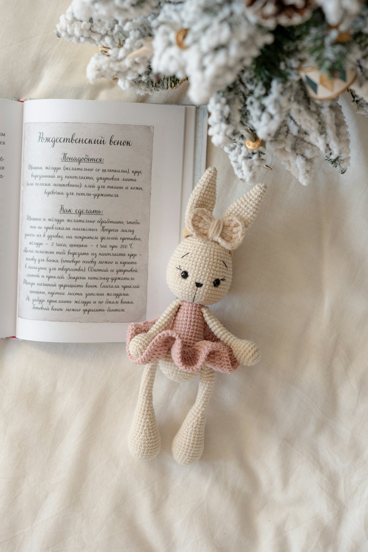A stuffed animal sitting next to an open book
