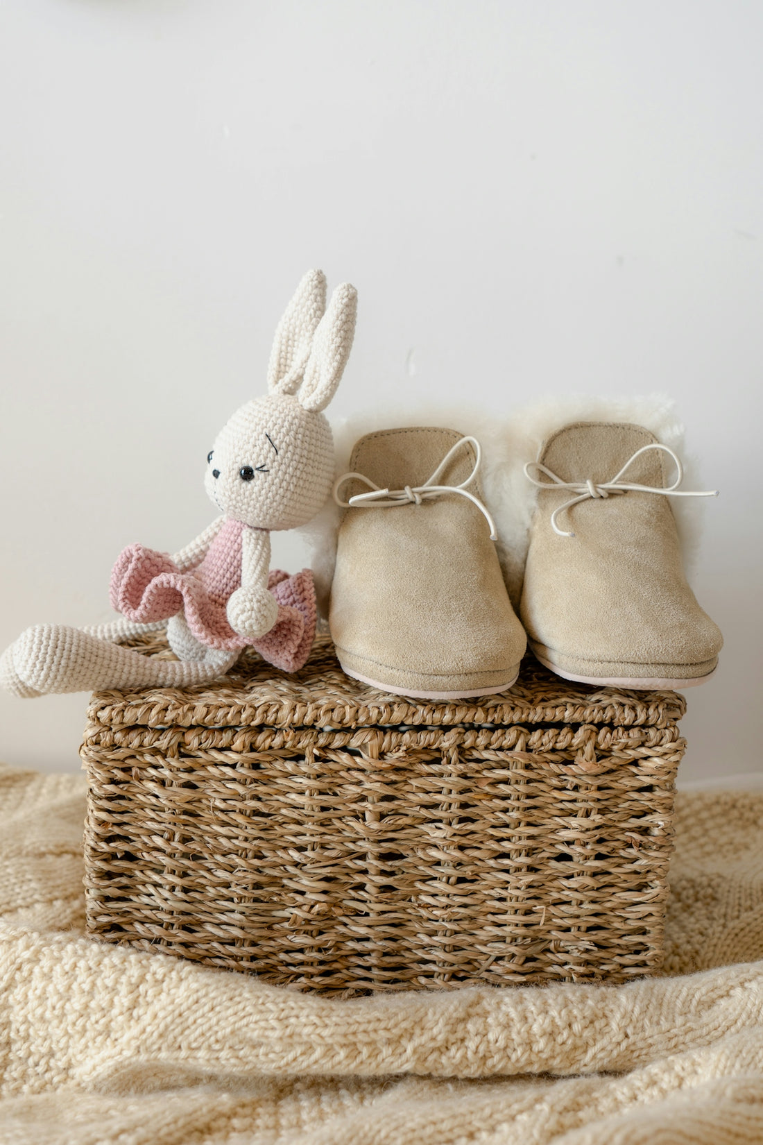 A basket with a stuffed animal and a pair of shoes