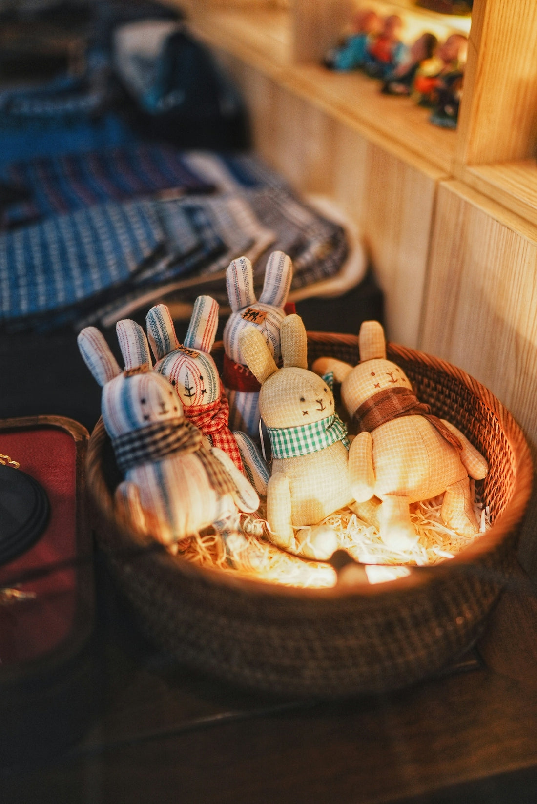 Stuffed bunny toys in a basket with scarves